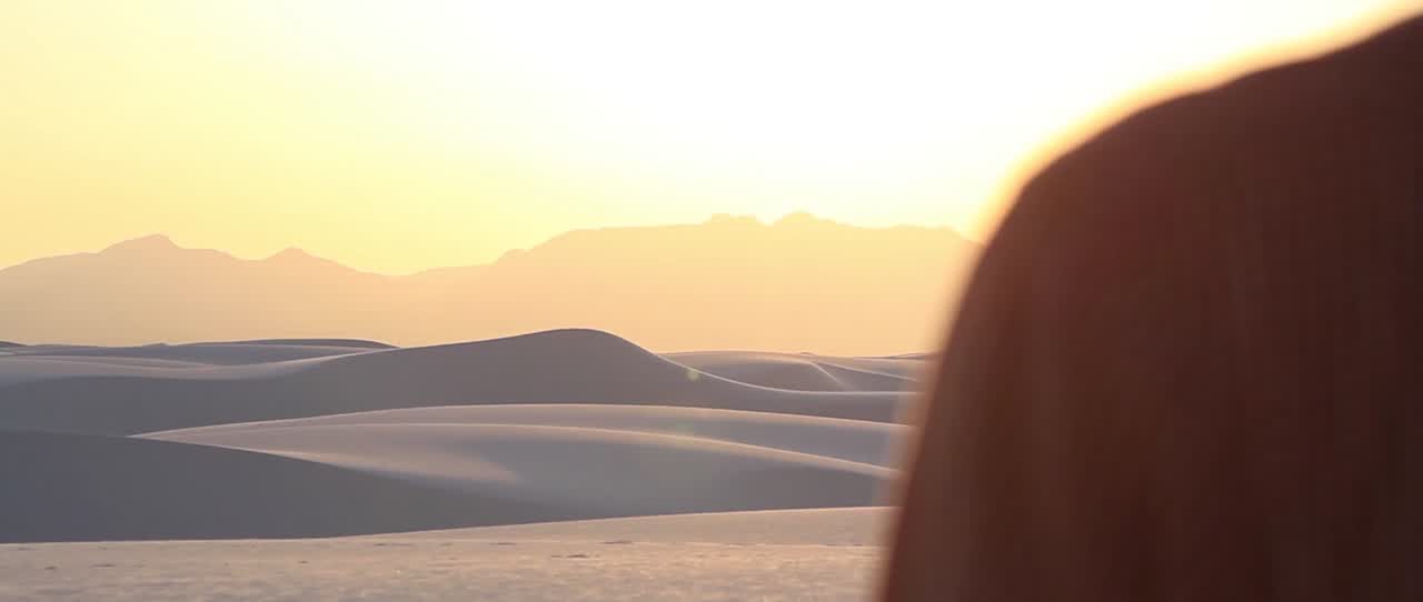 Halcyon Dreams film still: sunlit desert dunes and distant mountains